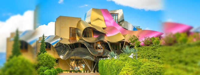 Trip Russia Reisetipps - Marqués de Riscal Design Hotel, Bilbao, Elciego, Spanien. Fantastisch galaktisch, unverkennbar ein Werk von Frank O. Gehry. Inmitten idyllischer Weinberge in der Rioja Region des Baskenlandes, bezaubert das schimmernde Bauobjekt mit einer Struktur bunter, edel glänzender verflochtener Metallbänder. Glanz im Baskenland - Es muss etwas ganz Besonderes sein. Emotional, zukunftsweisend, einzigartig. Denn in dieser Region, etwa 133 km südlich von Bilbao, sind Weingüter normalerweise nicht für die Öffentlichkeit zugänglich.
